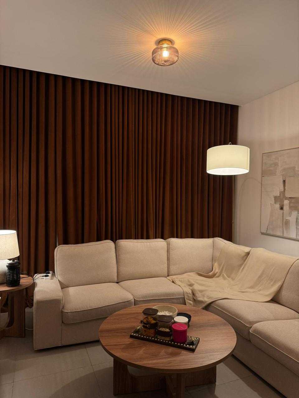 Deep chocolate velvet blackout insulation curtains under tailored lighting