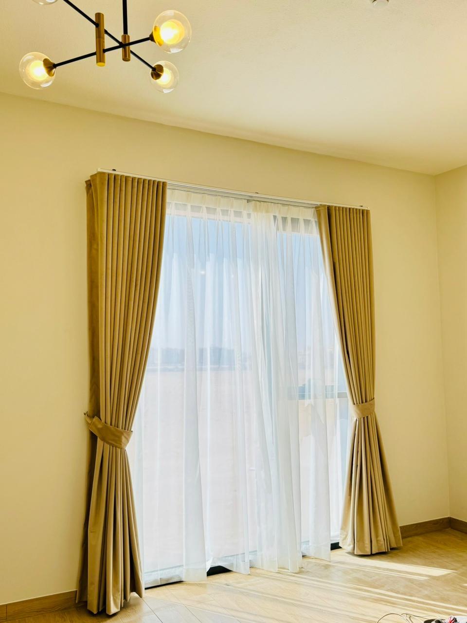 Lightweight sheer wave-fold curtains framing a seamless transition to a private balcony terrace