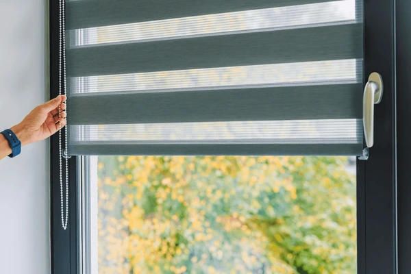 Luxury blackout roller blinds installed in a Dubai villa window with layered privacy bands