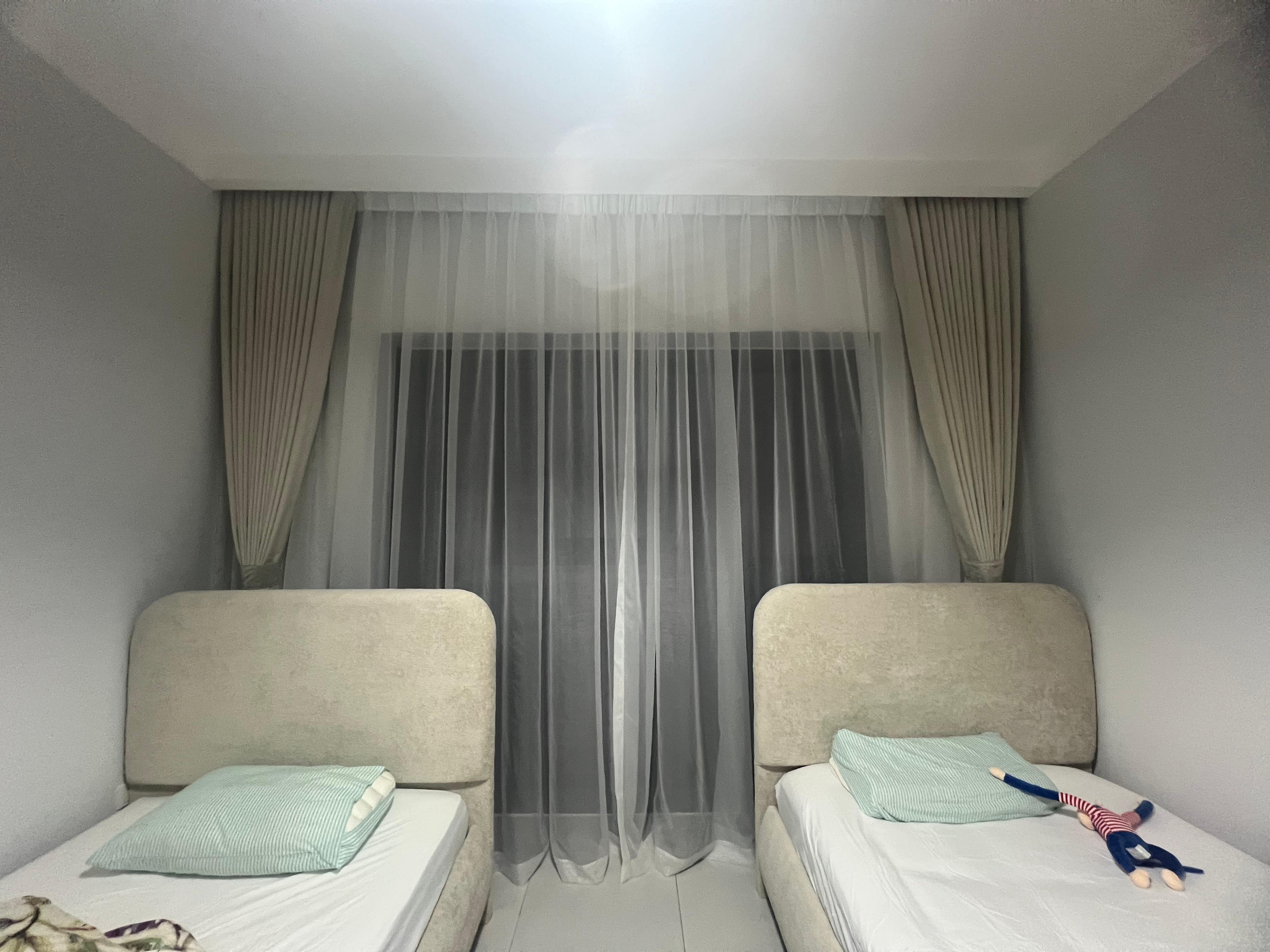 Grand automated drapes tailored for architectural double-height windows