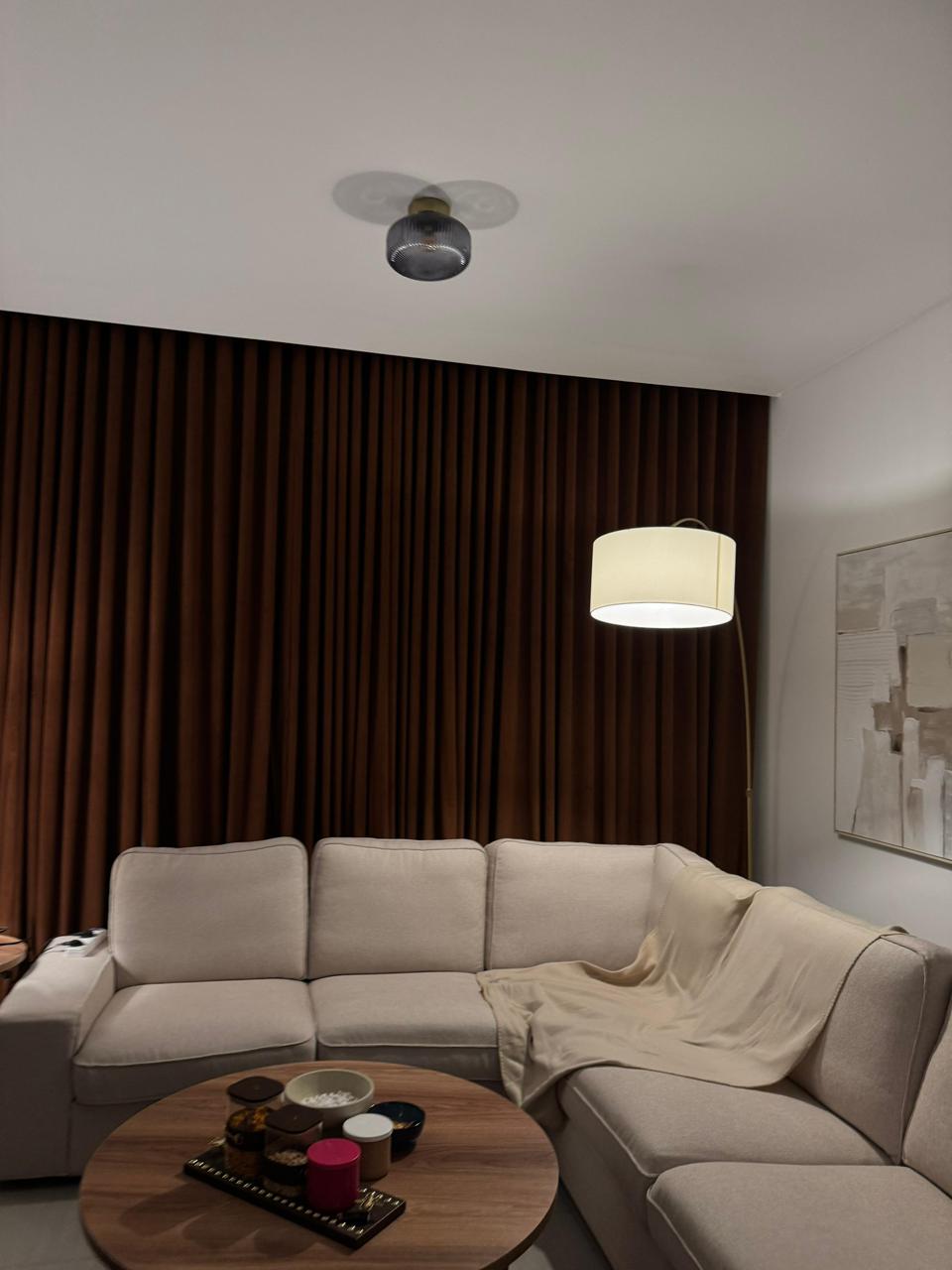 Multi-window symmetric installation featuring classic taupe dress curtains